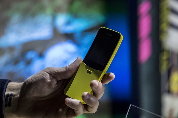 An attendee holds a yellow Nokia 8110 4G smartphone manufactured by HMD Global Oy during a launch event ahead of the...