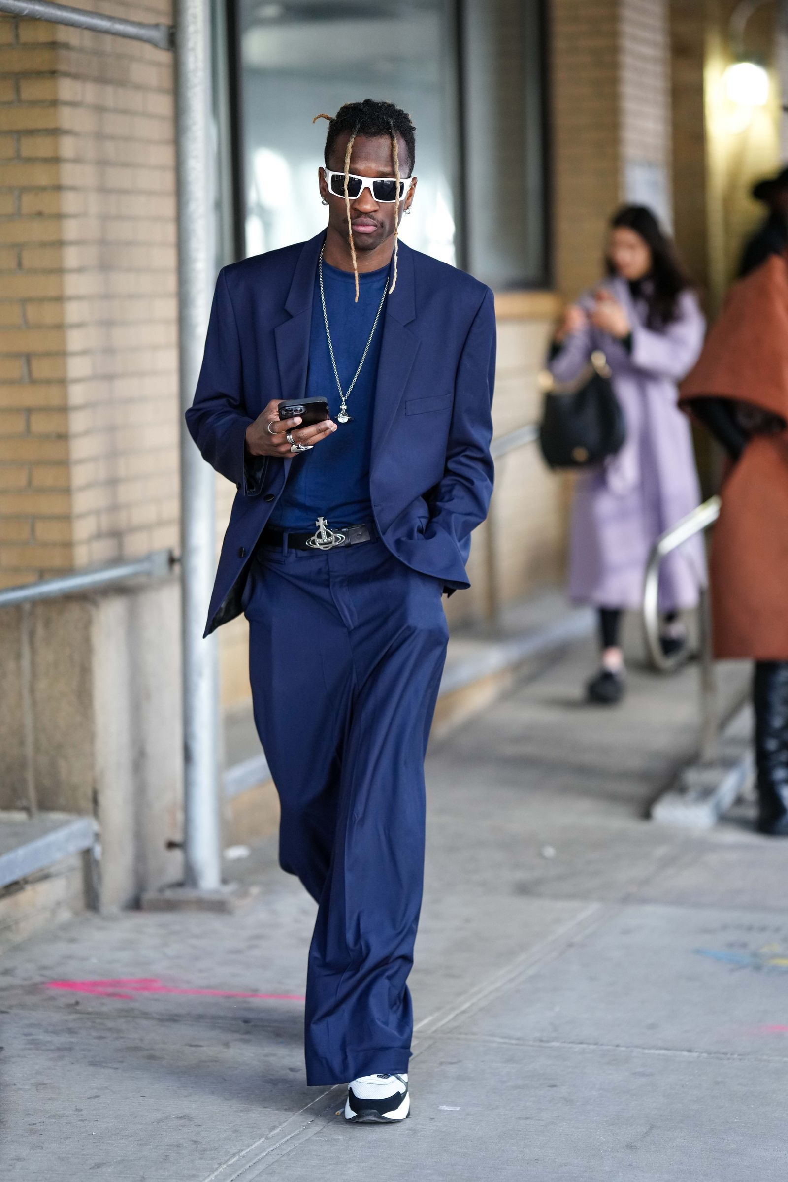 NEW YORK NEW YORK  FEBRUARY 10 A guest wears white sunglasses a navy blue tshirt a navy blue blazer jacket matching navy...