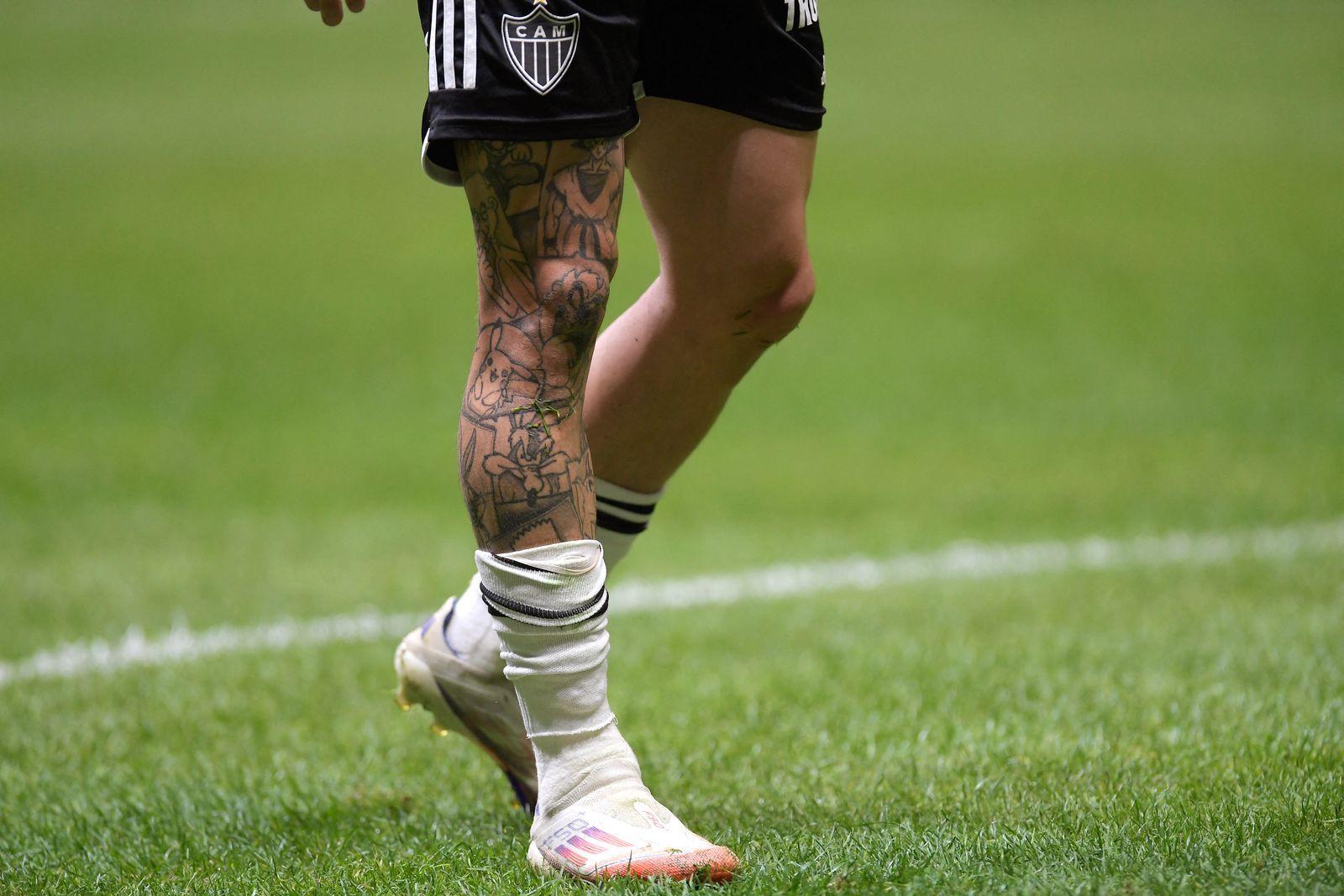 Atletico Mineiro's midfielder Bernard tattoo on his right leg is pictured as he walks during the Copa Libertadores round...