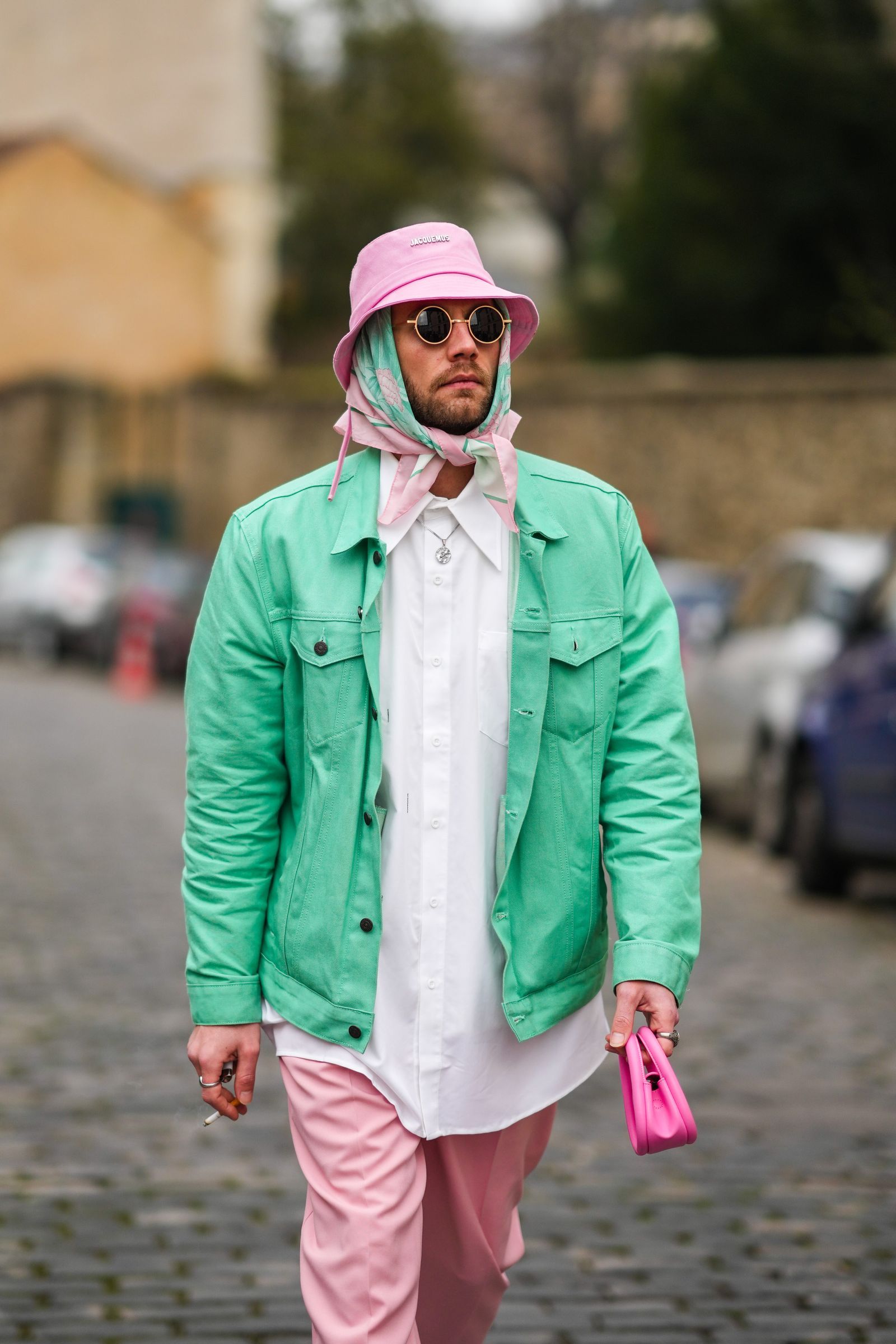 PARIS FRANCE  JANUARY 22 Influencer Karb wears a pale pink bob from Jacquemus gold sunglasses a pale green and pink...