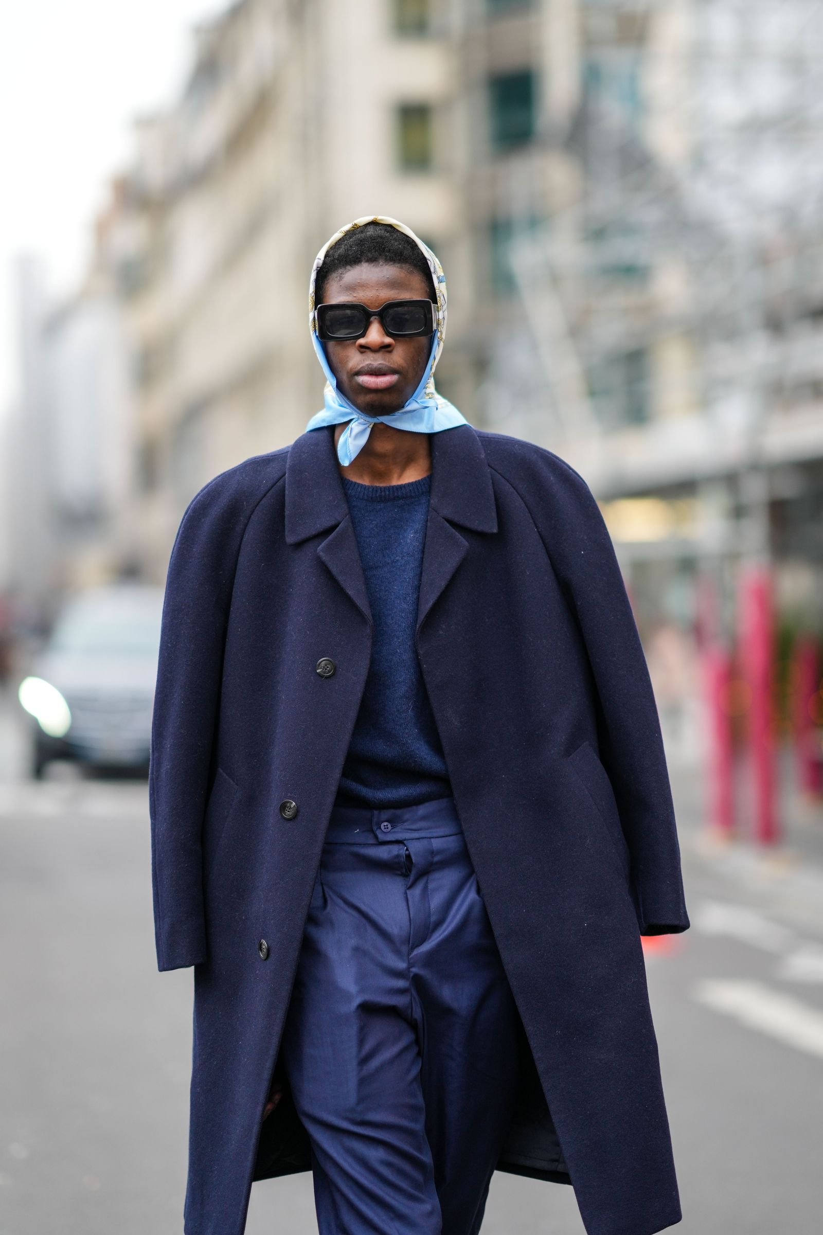 PARIS FRANCE  JANUARY 27 A guest wears a pale blue with gold and white print pattern silk scarf black sunglasses a navy...