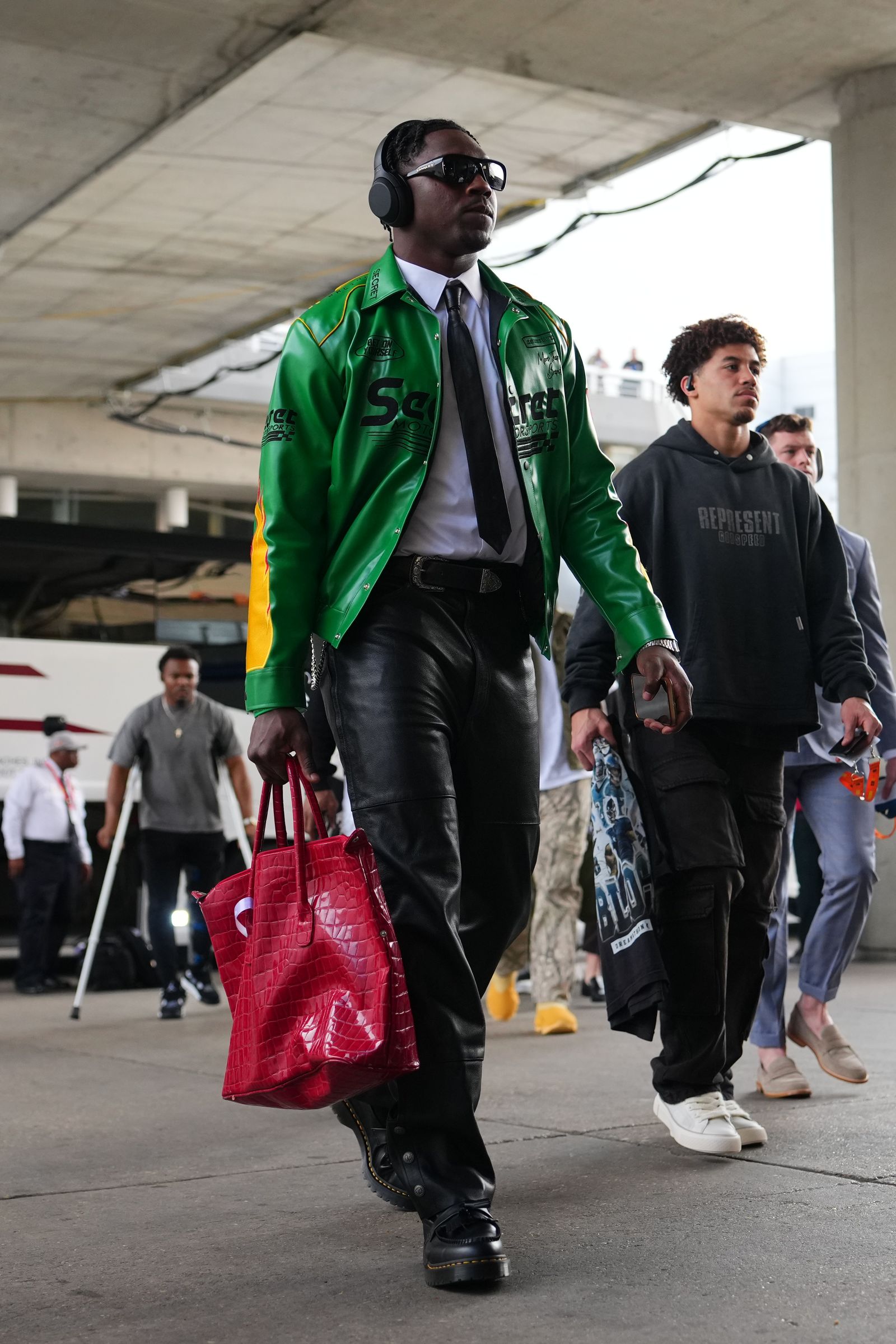 Image may contain Dontrelle Inman Pedestrian Person Accessories Bag Handbag Walking Clothing Coat and Formal Wear
