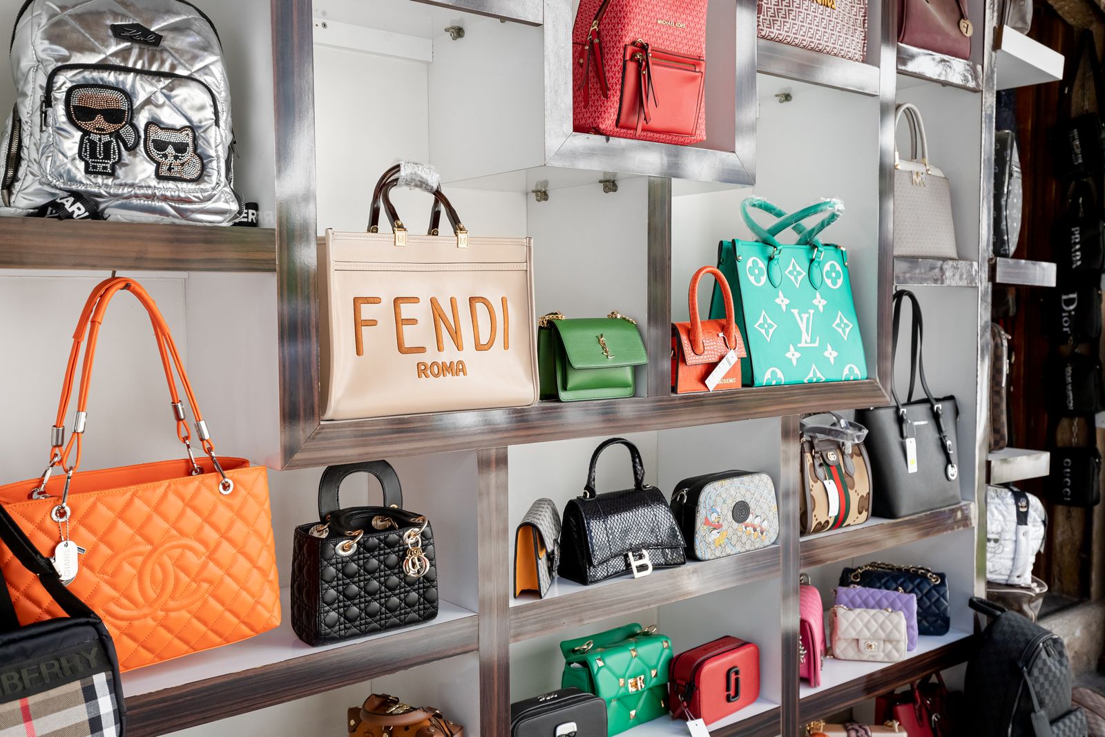 16 May 2022 Antalya Turkiye Counterfeit fakes of bags of famous world brands of fashion accessories for sale at market ...