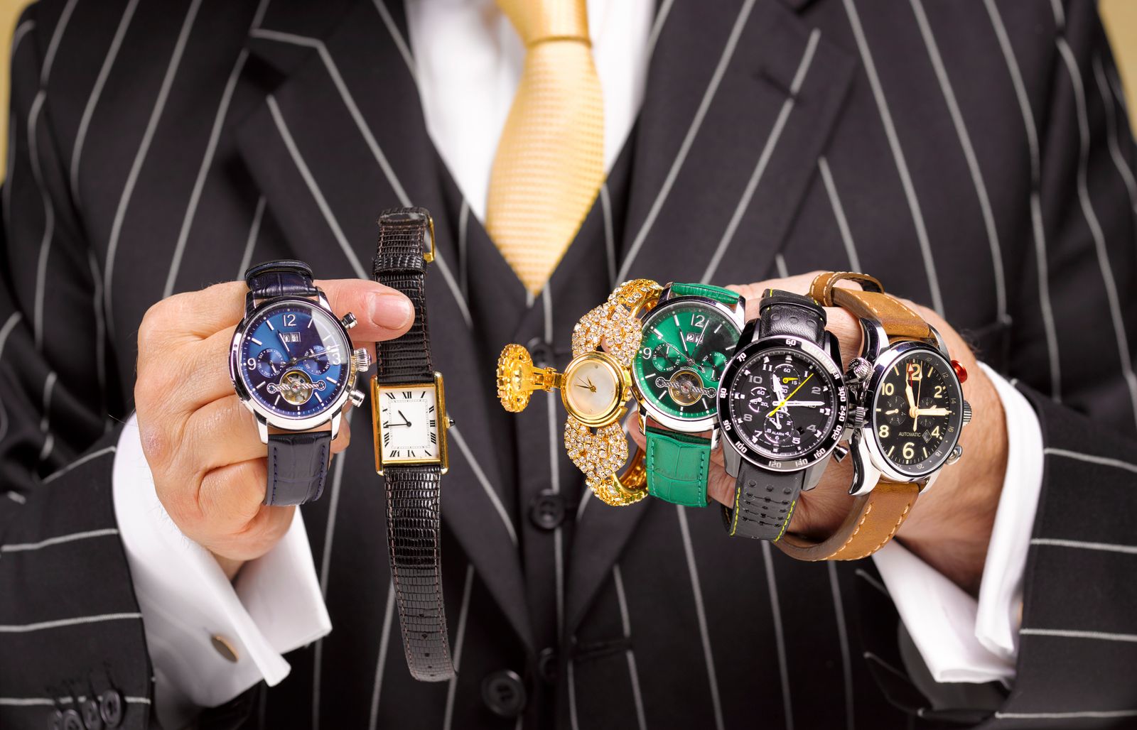 Close up of a black market trader's hands with a collection of watches.