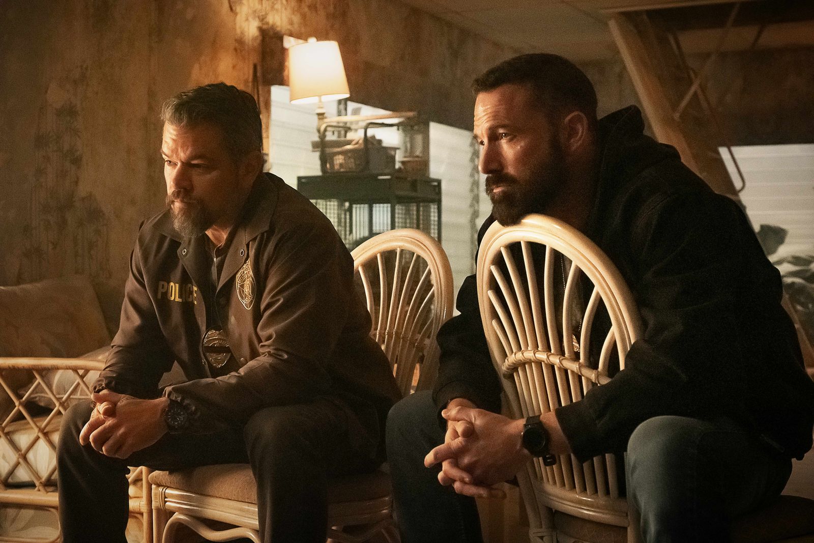 Image may contain Ben Affleck Adult Person Wristwatch Conversation Chair Furniture Head Face and Lamp