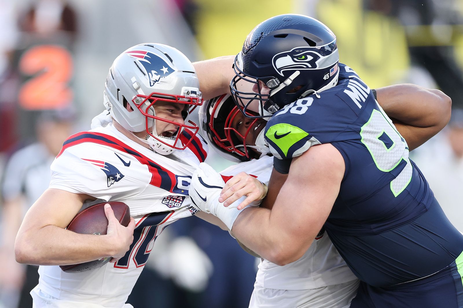 SANTA CLARA CALIFORNIA  FEBRUARY 08 Drake Maye 10 of the New England Patriots is sacked by Rylie Mills 98 of the Seattle...