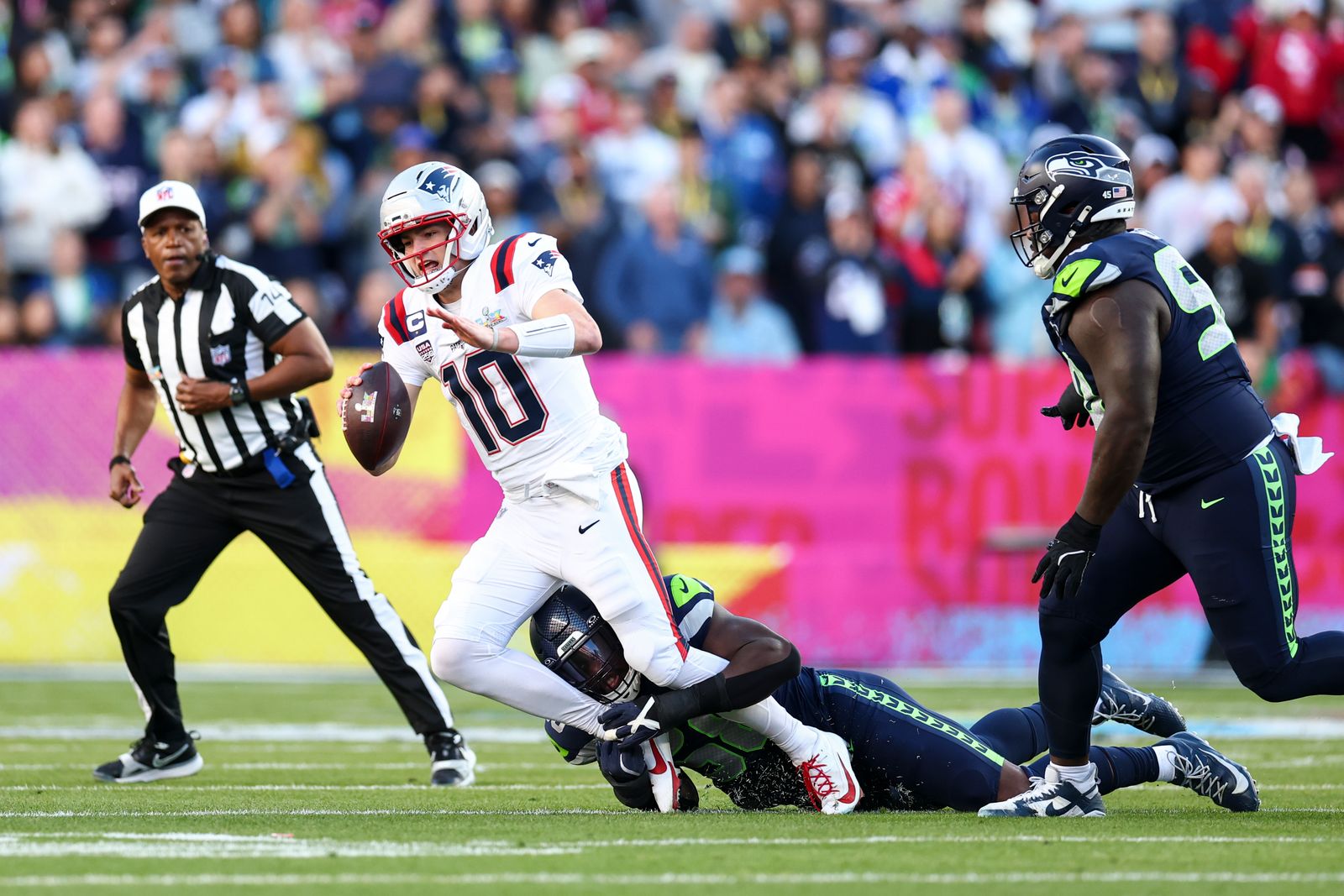 SANTA CLARA CALIFORNIA  FEBRUARY 8 Seattle Seahawks linebacker Derick Hall  gets the sack on New England Patriots...