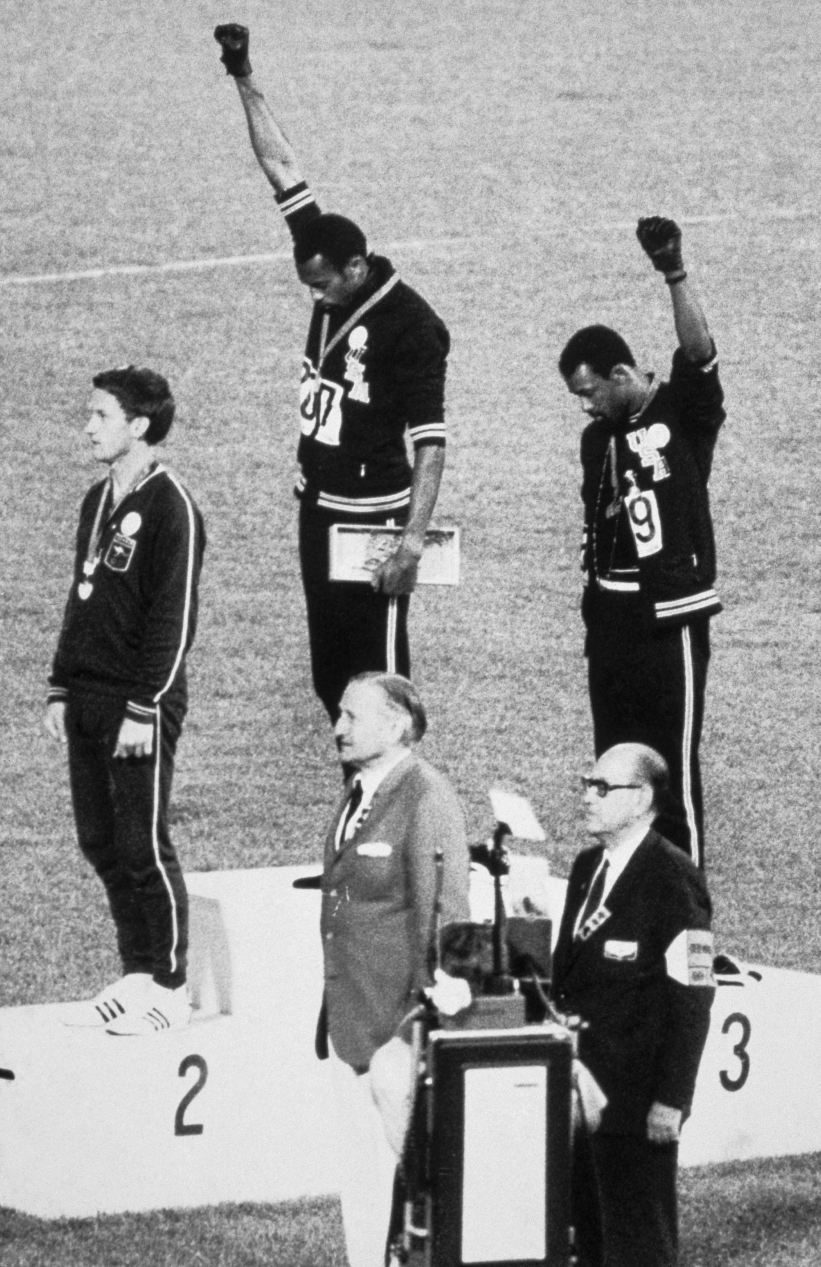 During the award presentation for the Menâ€™s 200meter event final at the 1968 Summer Olympics American athletes gold...